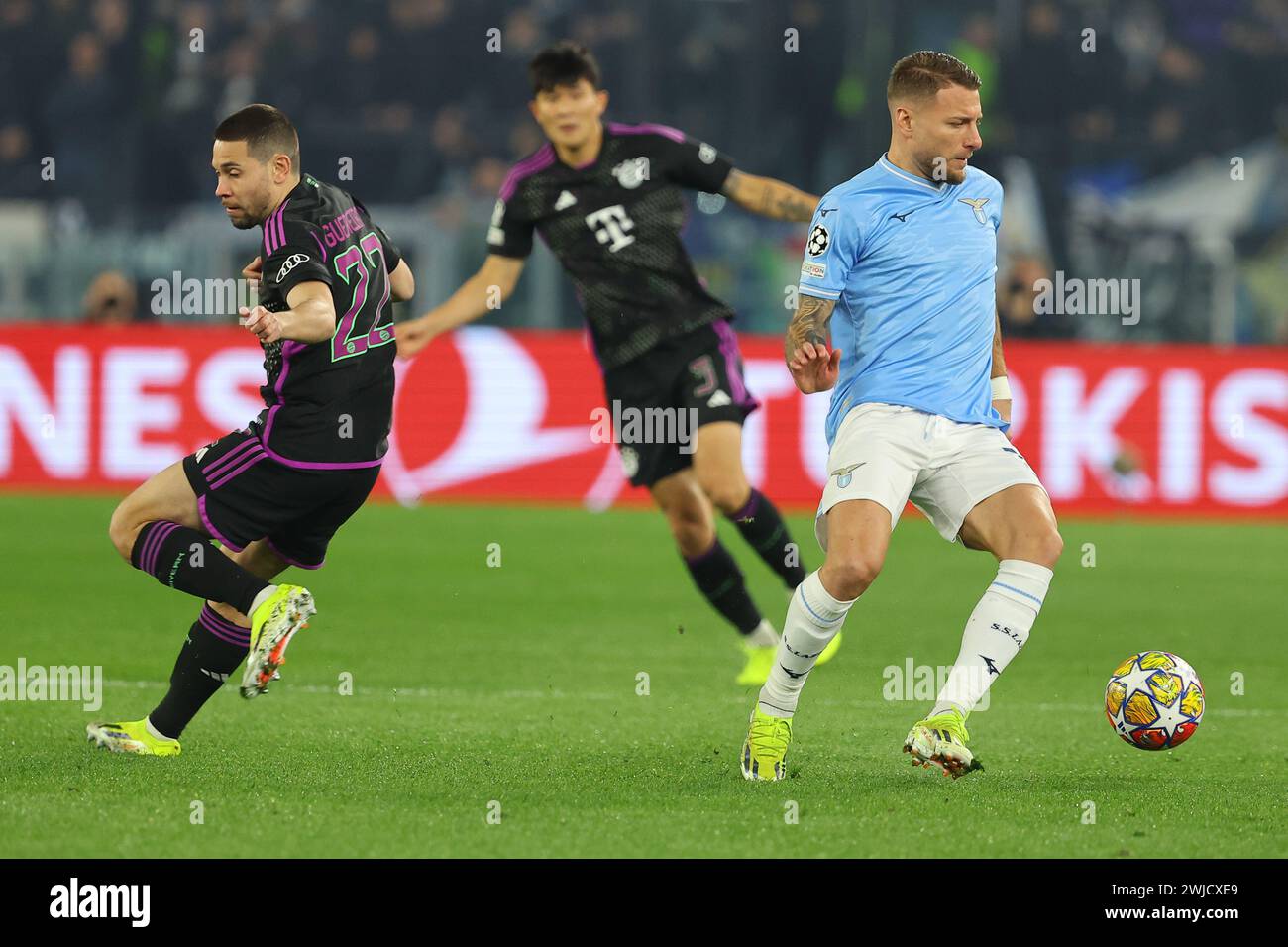 Rome, Italy. 14th Feb, 2024. Rome, Italy 14.2.2024: Raphael Guerreiro of Bayern Munchen fight for the ball with Ciro Immobile of Lazio during the Uefa Champions League 2023-2024, round of 16 football match SS Lazio vs FC Bayern Mucnhen at Olympic Stadium in Rome. Credit: Independent Photo Agency/Alamy Live News Stock Photo