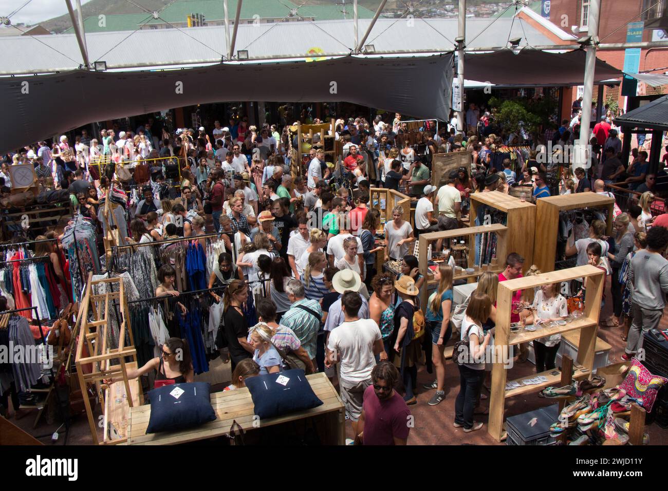 Neighbours goods market time in Capetown. Young hip people gather to enjoy live music, good food, local designer clothes and the boho vibe. Stock Photo