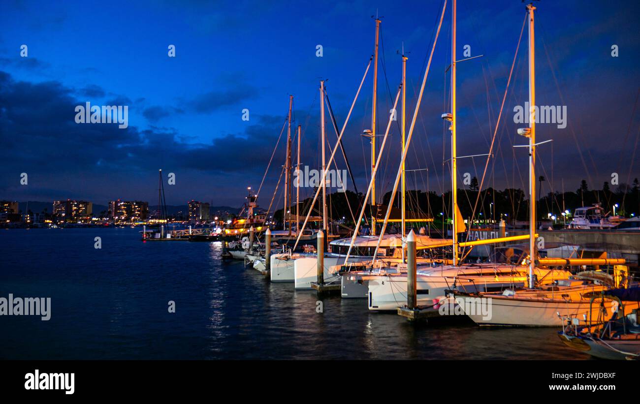Sailboats at dusk in Marina del Rey, California, a harbour in the eponymous town in Los Angeles County. Boats docked in a boat slip at night. Stock Photo