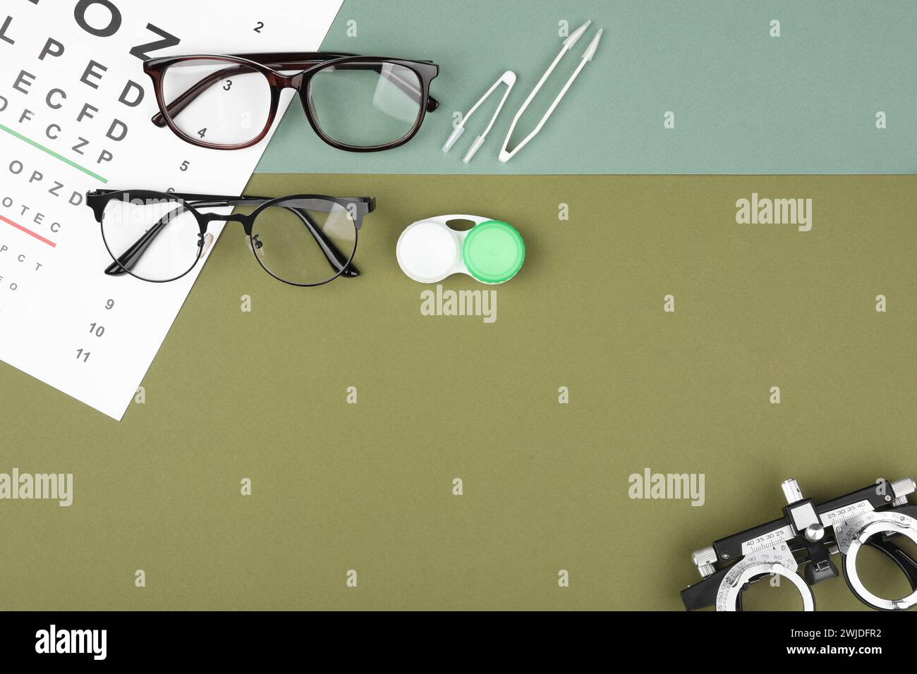 Lay Vision Flat lay composition with vision test chart and glasses on color ...