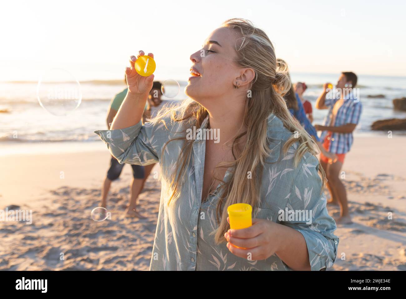 Woman sunset beach carefree hi-res stock photography and images - Alamy
