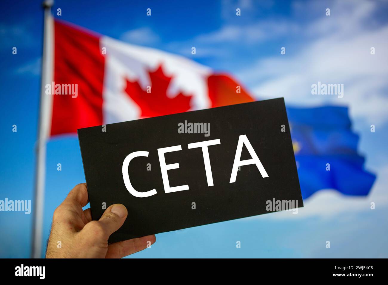 Sign reading CETA in front of the flags of Canada and the European Union. The abbreviation CETA stands for a free trade agreement between the two part Stock Photo
