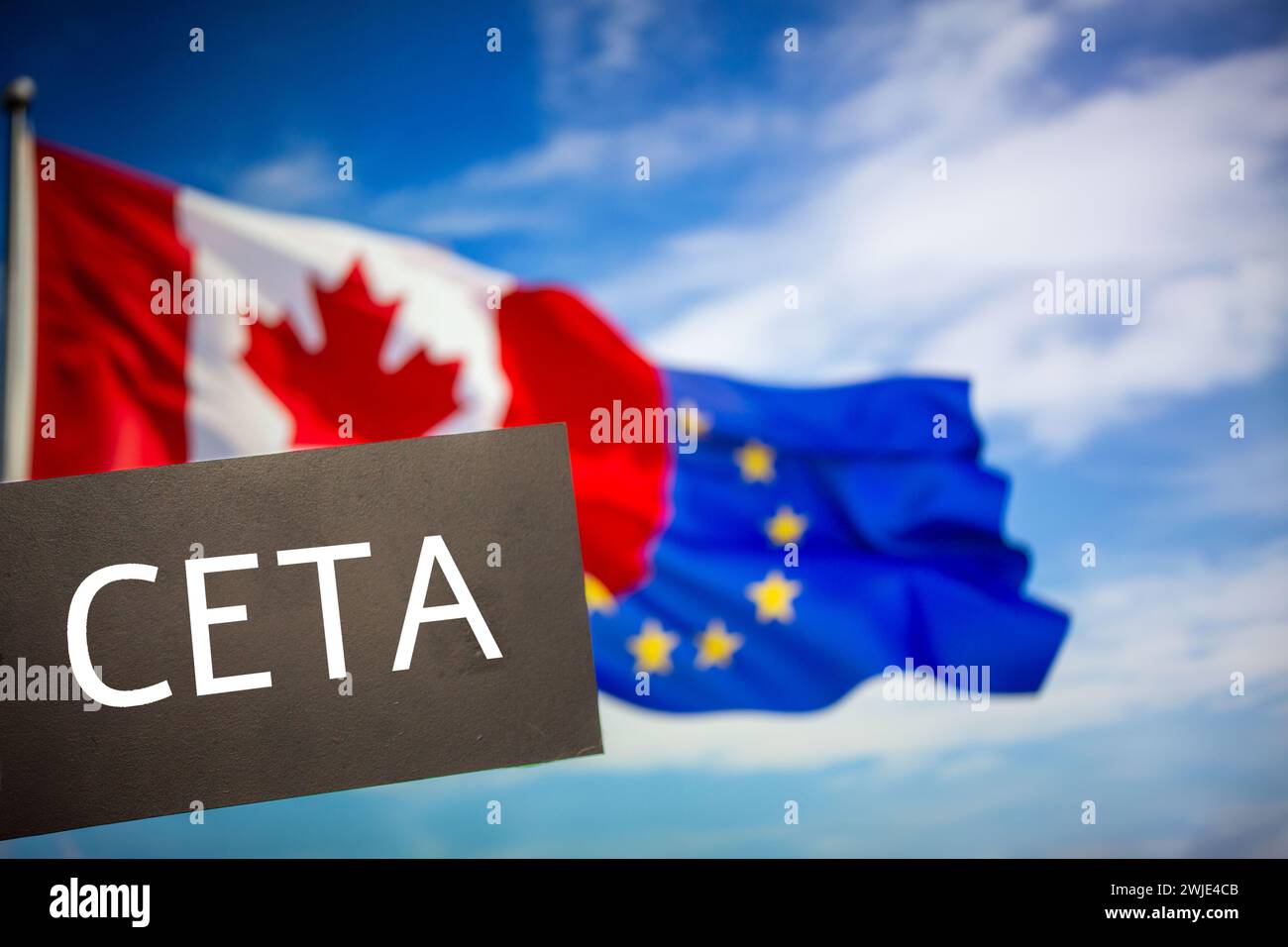 Sign reading CETA in front of the flags of Canada and the European Union. The abbreviation CETA stands for a free trade agreement between the two part Stock Photo