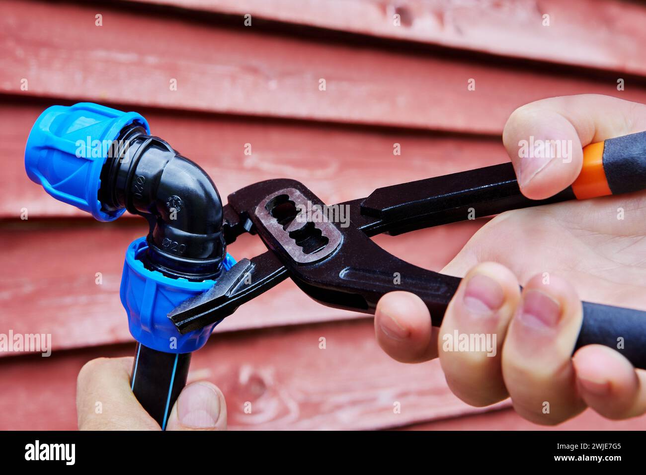 Adjustable plumbers wrench pliers for pipes are used to tighten compression clamp nut of elbow