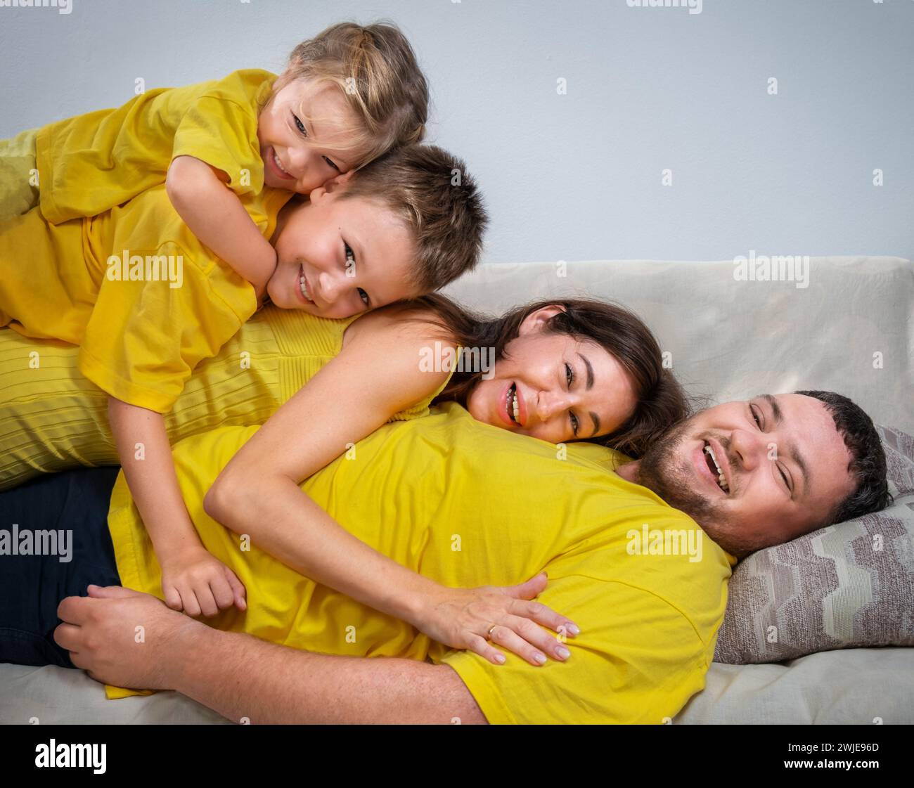 Portrait family lying on top hi-res stock photography and images - Alamy