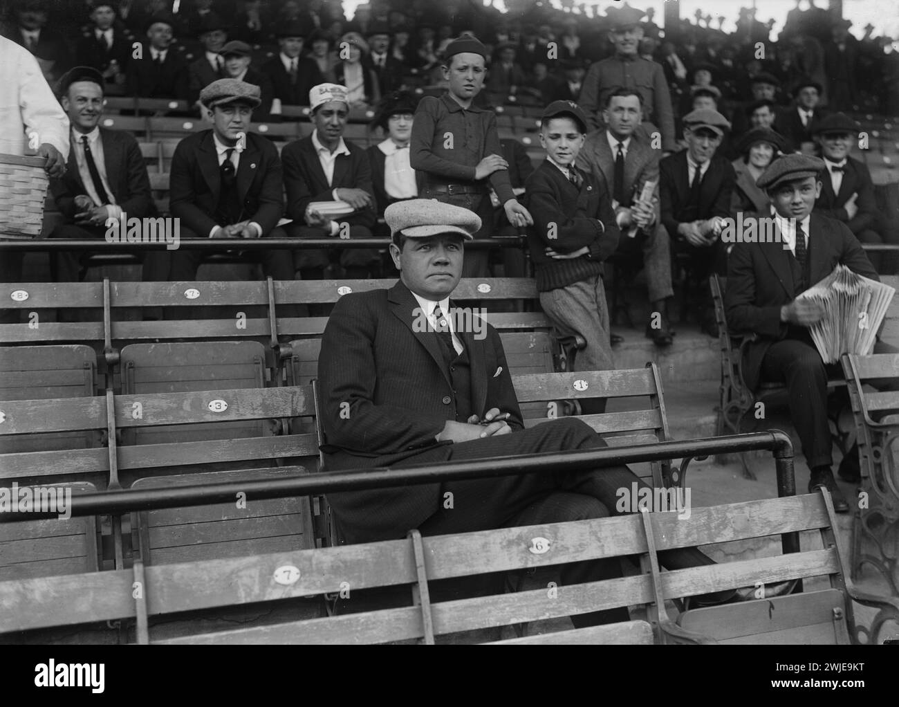 Baseball player Babe Ruth seated in the stands at baseball game