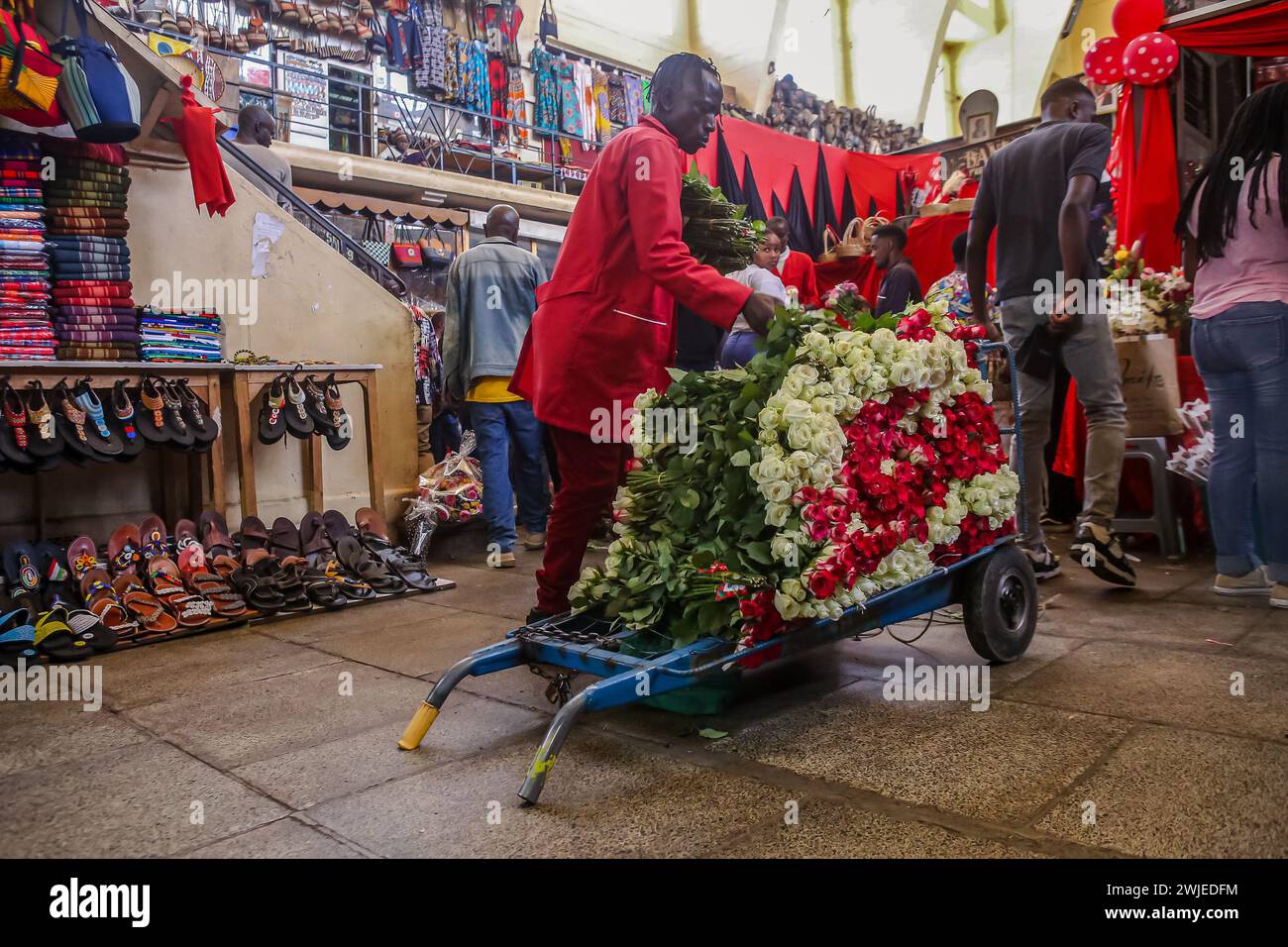 A Kenyan man delivers flowers at a shop at the Nairobi City Market