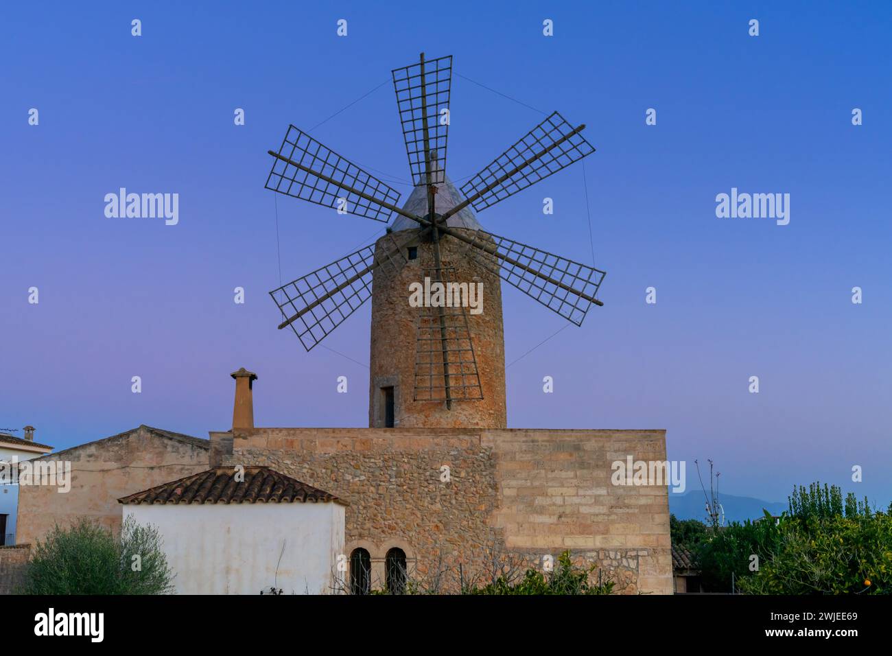 Algaida, Spain - 21 January, 2024: historic windmill in the country town of Algaida in the interior of Mallorca at sunrise Stock Photo