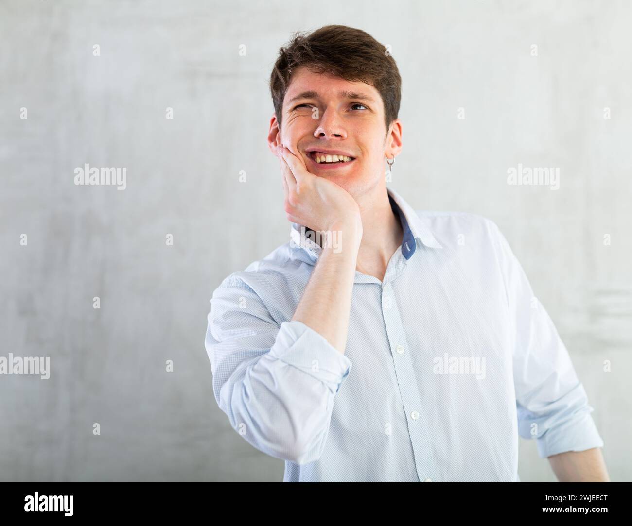 Young guy holding his cheek with toothache Stock Photo