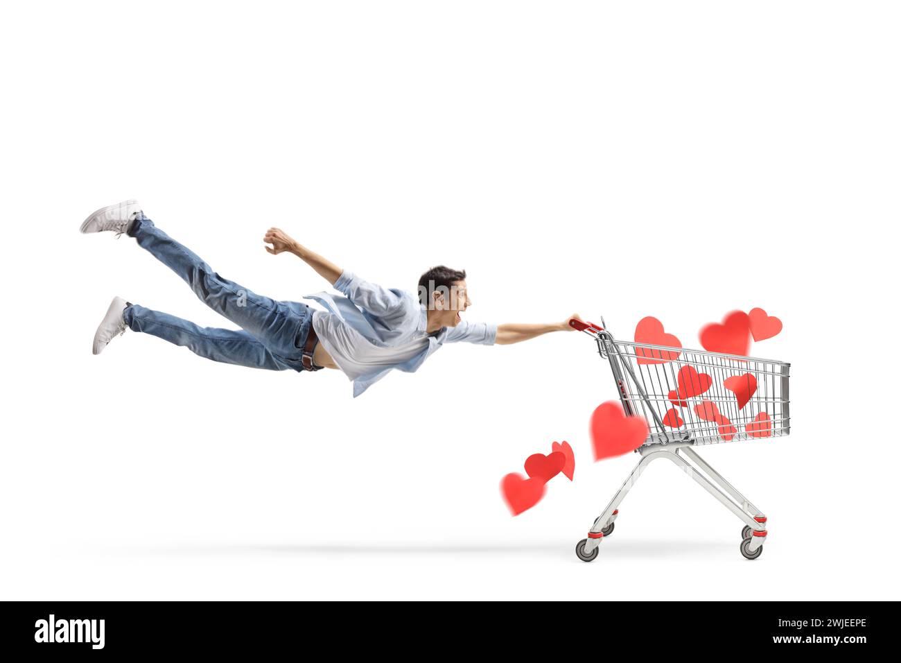Man flying with a shopping cart full of read hearts isolated on white background, head over hills in love concept Stock Photo