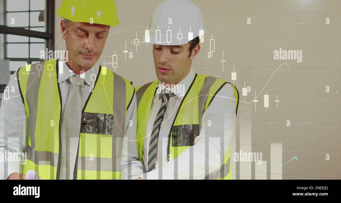 Two male architects discuss plans with graphs Stock Photo