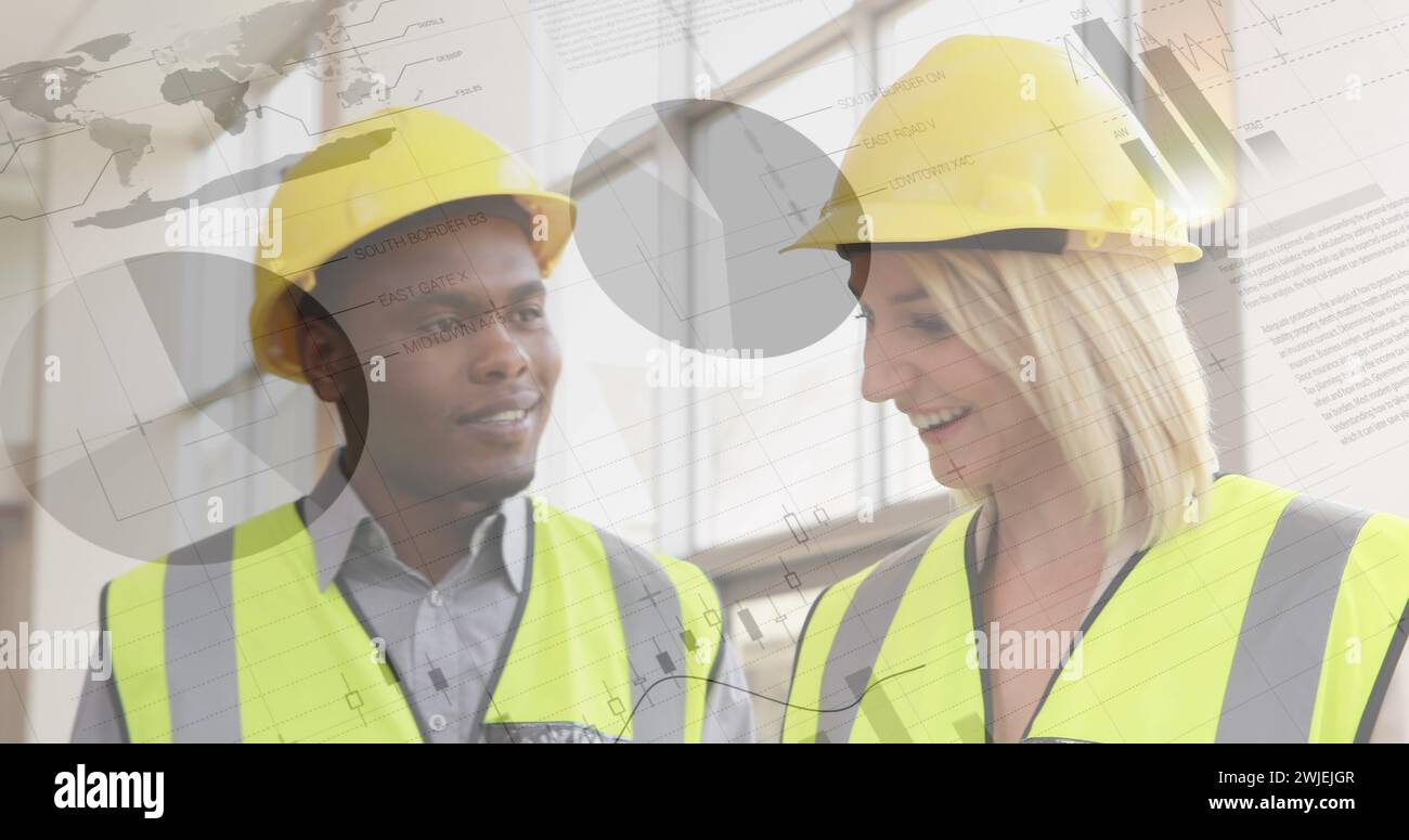 Two architects review building plans with foreground graphs Stock Photo