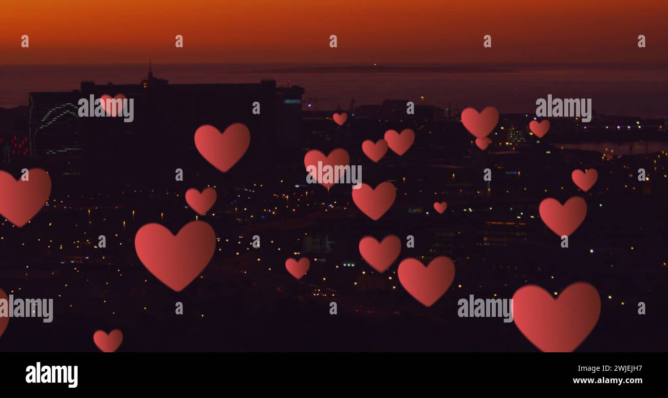 Floating hearts over a nighttime cityscape Stock Photo - Alamy