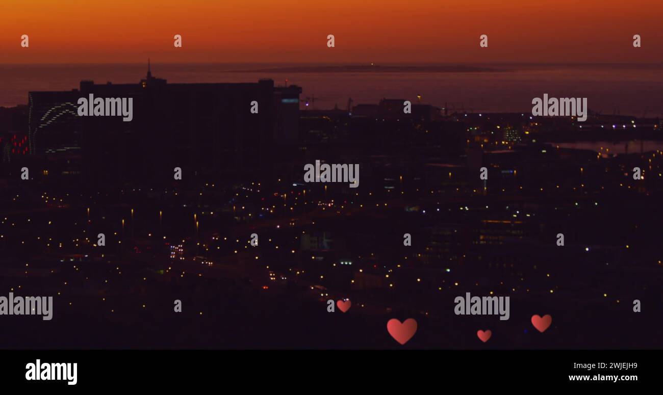 Floating hearts over a nighttime cityscape Stock Photo - Alamy