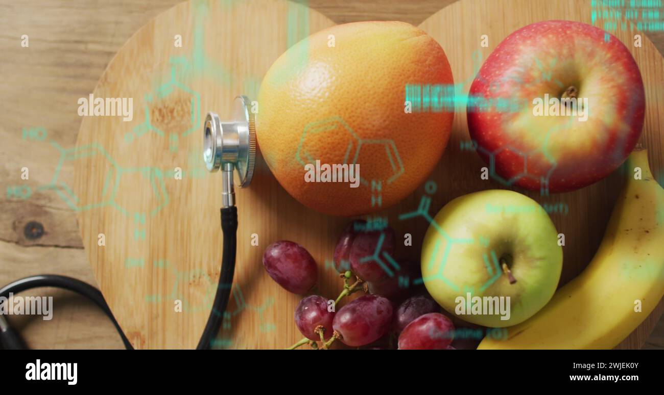 Image of data processing over stethoscope and fruit Stock Photo