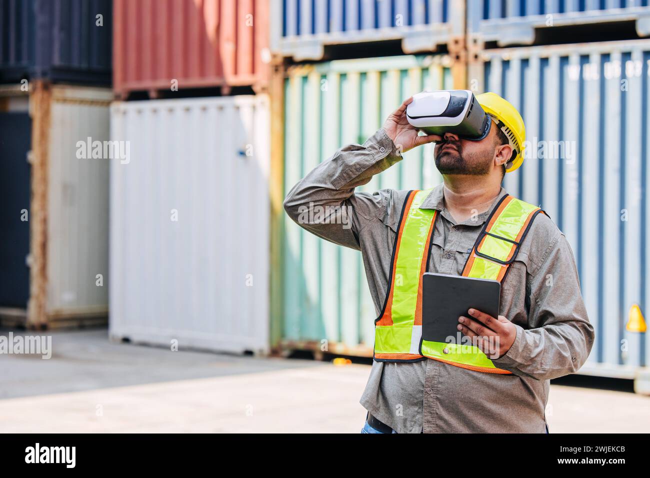 Worker Using VR Vision Pro Technology Equipment Headset Device Work at Container Yard Construction site Innovation in Logistics Industry Stock Photo