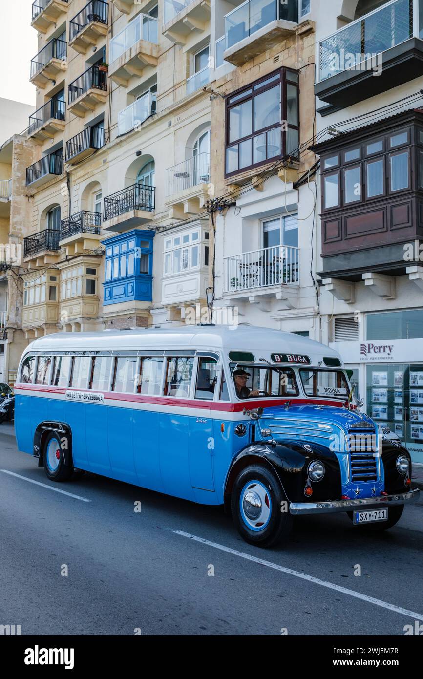 A vintage Thames bus on an excursion driving through St Julian's Bay, Malta Stock Photo