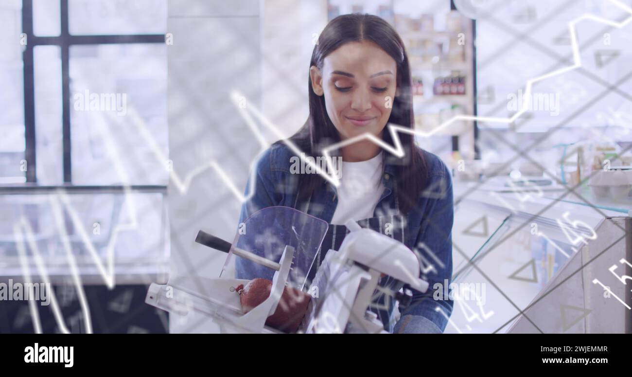 Image of data processing over caucasian female shop assistant cutting salami Stock Photo