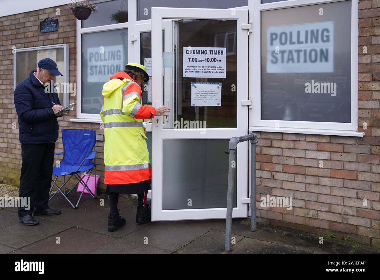 People arrive at Irchester Village Hall, as voting gets underway in the