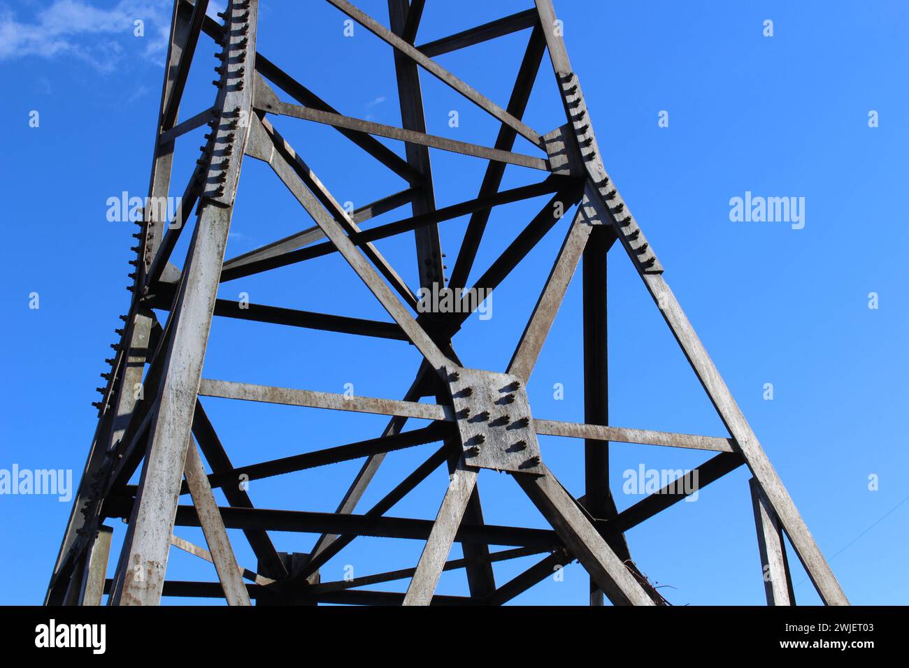 Power line high-voltage. View from below upwards, against the blue sky ...