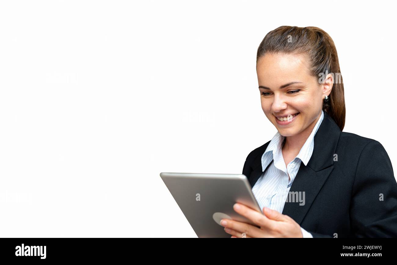 Isolate businesswoman in suit using her digital computer tablet and smiling. Stock Photo
