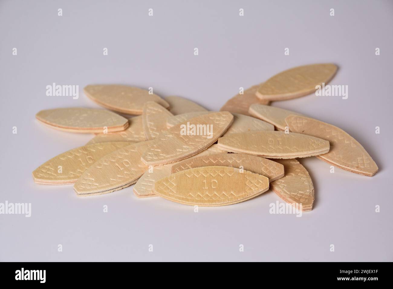 Biscuit joint isolated on light background.  Woodworking. Stock Photo