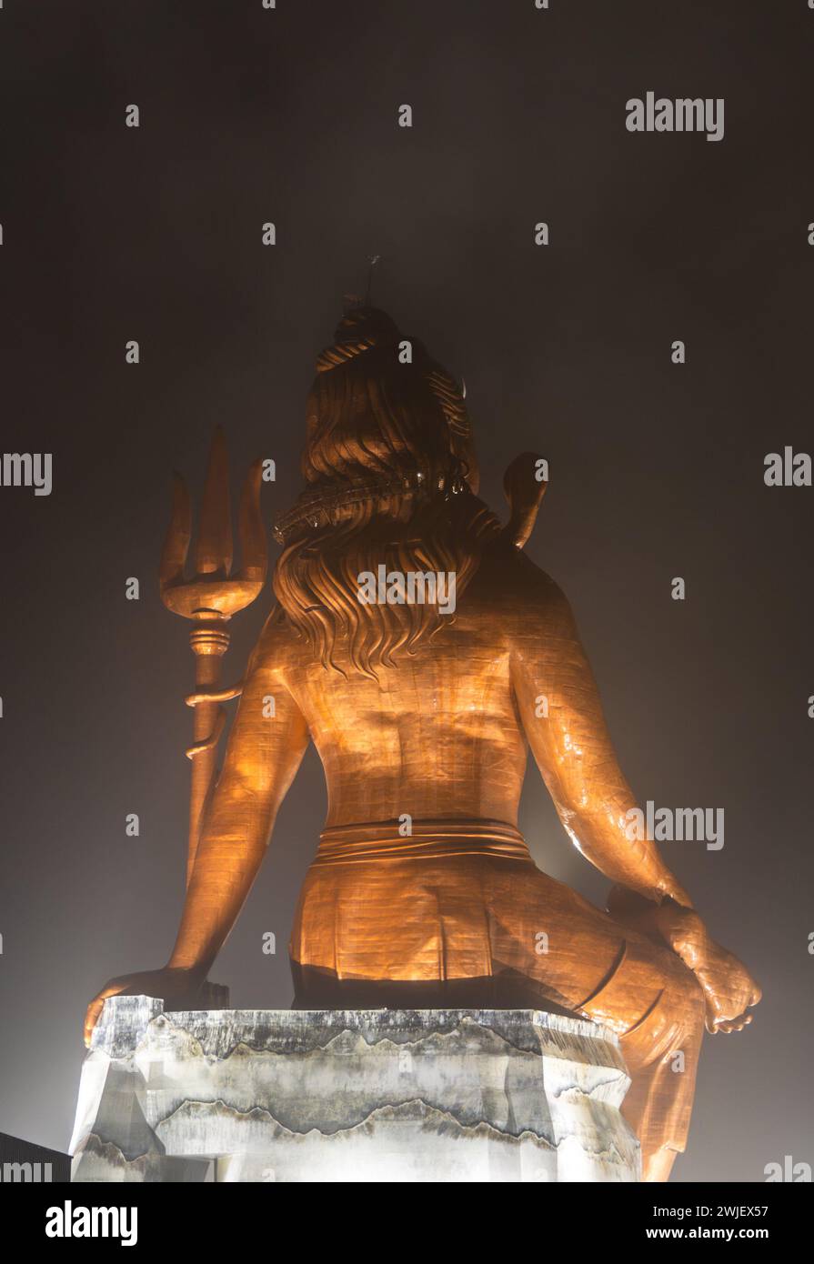 back view of hindu god lord shiva isolated statue at night from