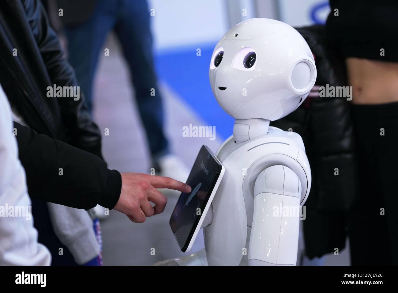 Turin, Italy - February 14, 2024: Pepper, a robotic assistant with an information screen, greets visitors to a stand at the Artificial Intelligence fo Stock Photo
