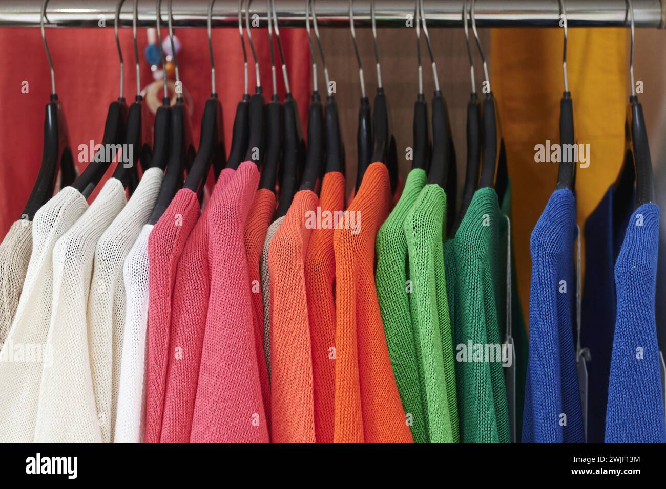 Savenay (north-western France): “Hyper U” hypermarket. Textile and garment section. Women’s clothing, colourful sweaters on hangers Stock Photo