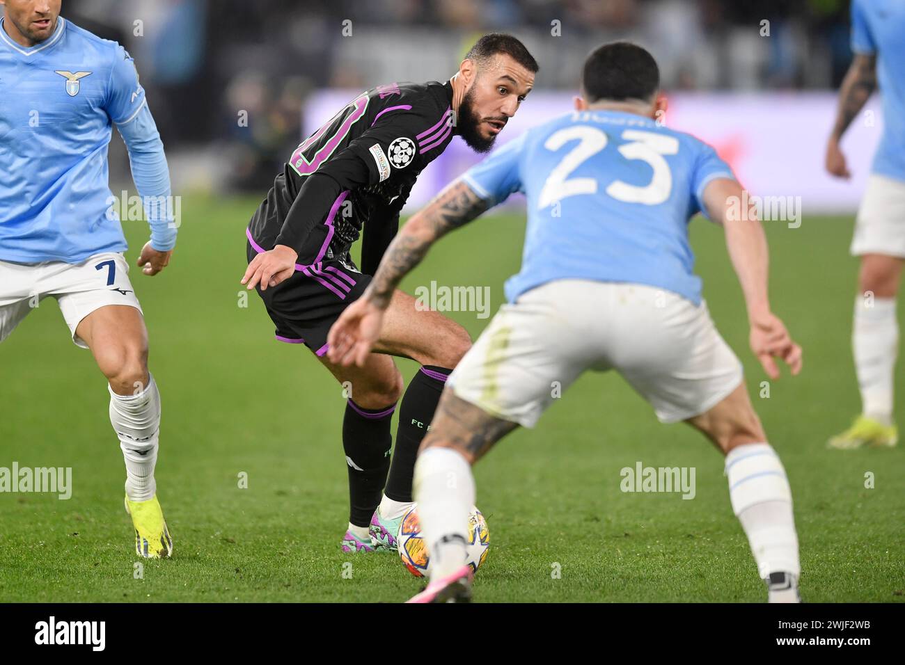 Noussair Mazraoui of Bayern Munechen and Elseid Hysaj of SS Lazio during  the Champions League football match between SS Lazio and FC Bayern Munchen at Olimpico stadium in Rome (Italy), February 14th, 2024. Stock Photo