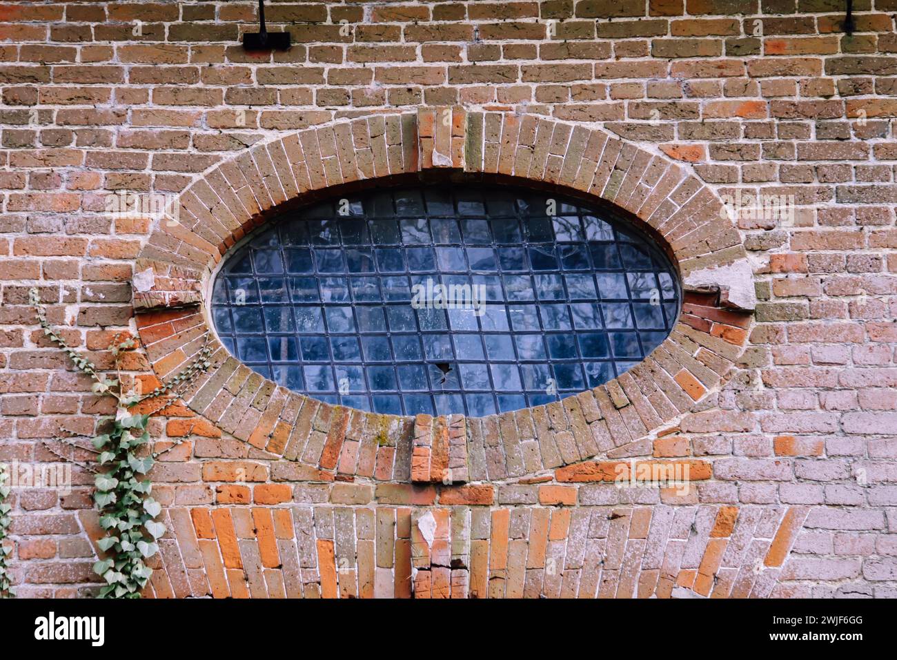 An Oval window above entrance at West Horsley Place (Button House), Surrey, England, UK, Feb