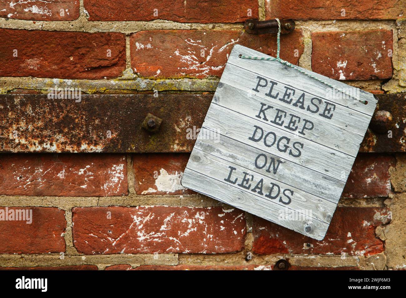 Sign saying Please keep dogs on leads, in the UK countryside, hanging