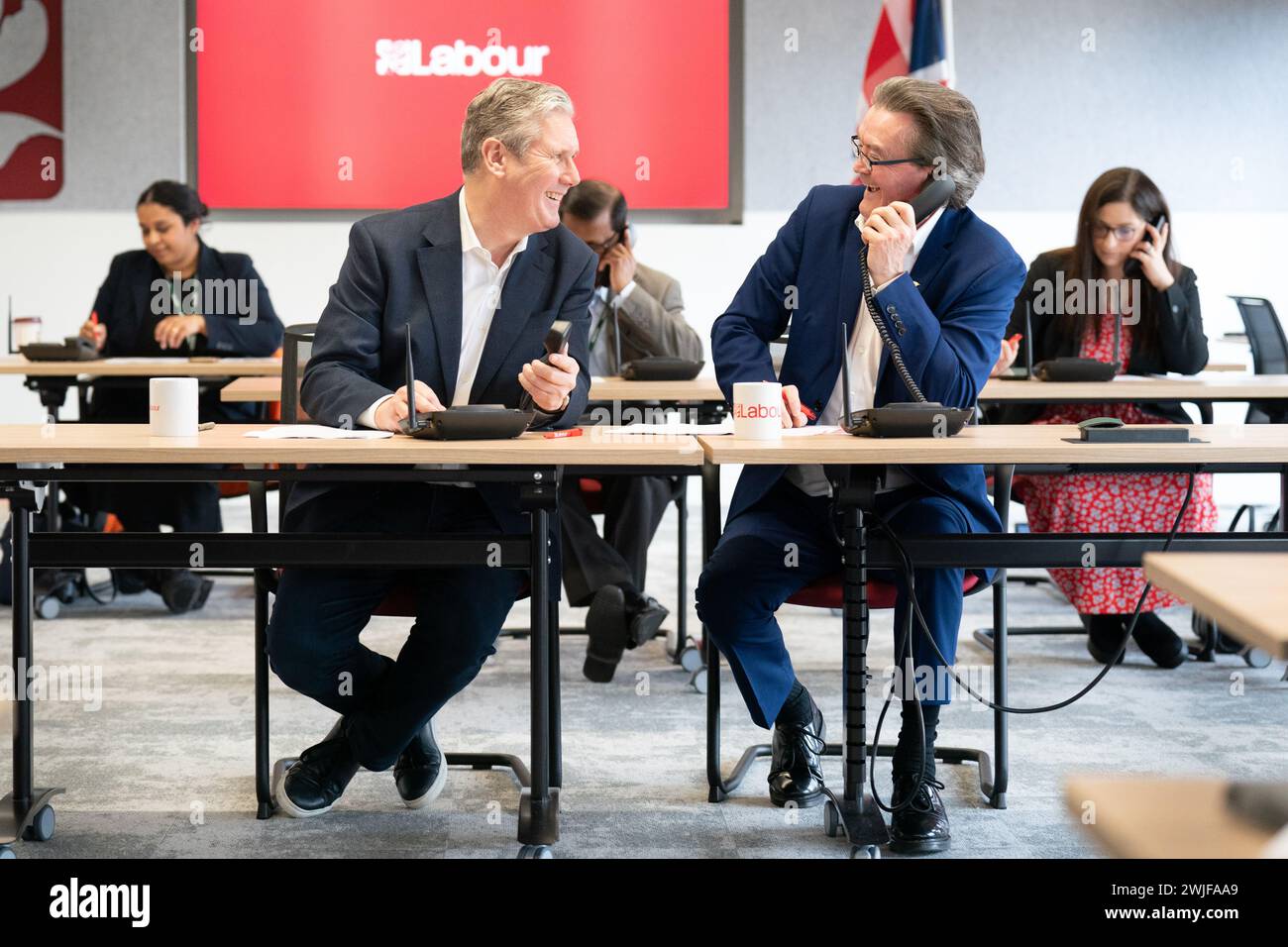 Labour leader Sir Keir Starmer (left) alongside canvassing voters by phone for the Wellingborough and Kingswood by-elections, at Labour HQ in London. Picture date: Thursday February 15, 2024. Stock Photo
