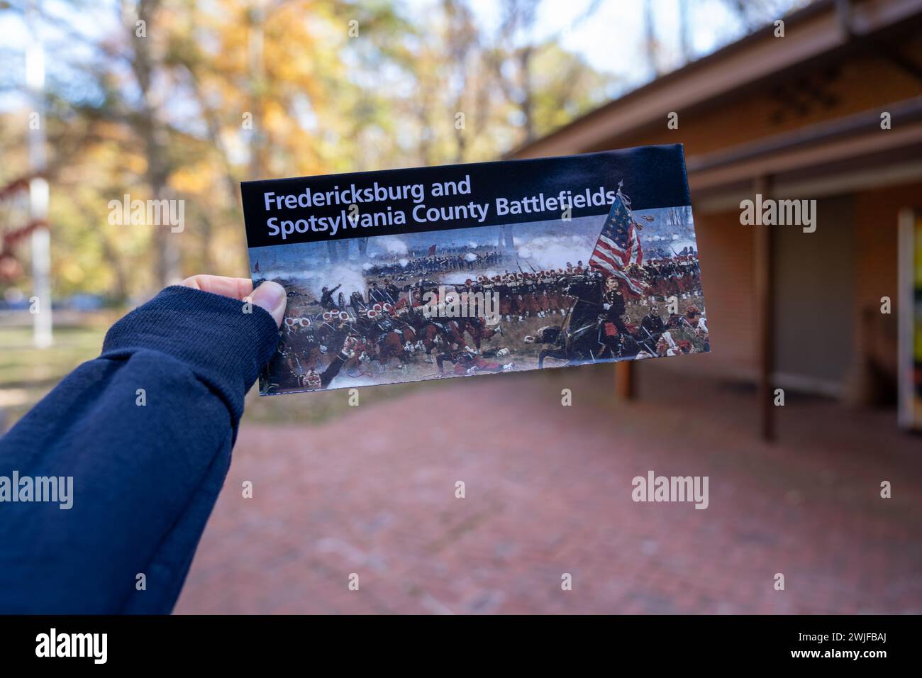 Chancellorsville, Virginia - November 4, 2023: Hand holds a National Parks map and brochure for Fredericksburg and Spotsylvania County battlefields Stock Photo
