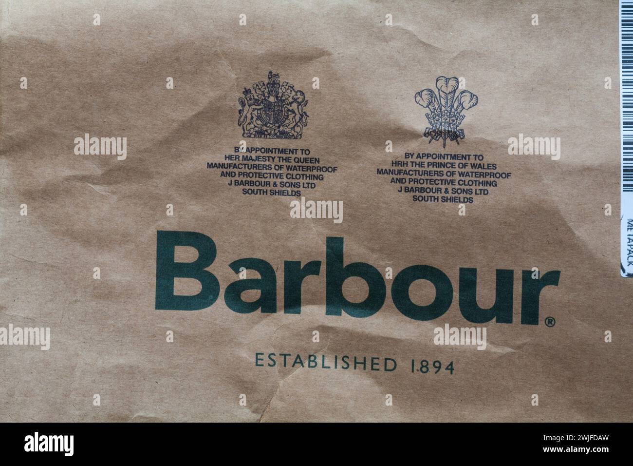 By appointment to her Majesty the Queen, By appointment to H.R.H. the Prince of Wales - Royal Warrants Royal Warrant on brown Barbour bag Stock Photo