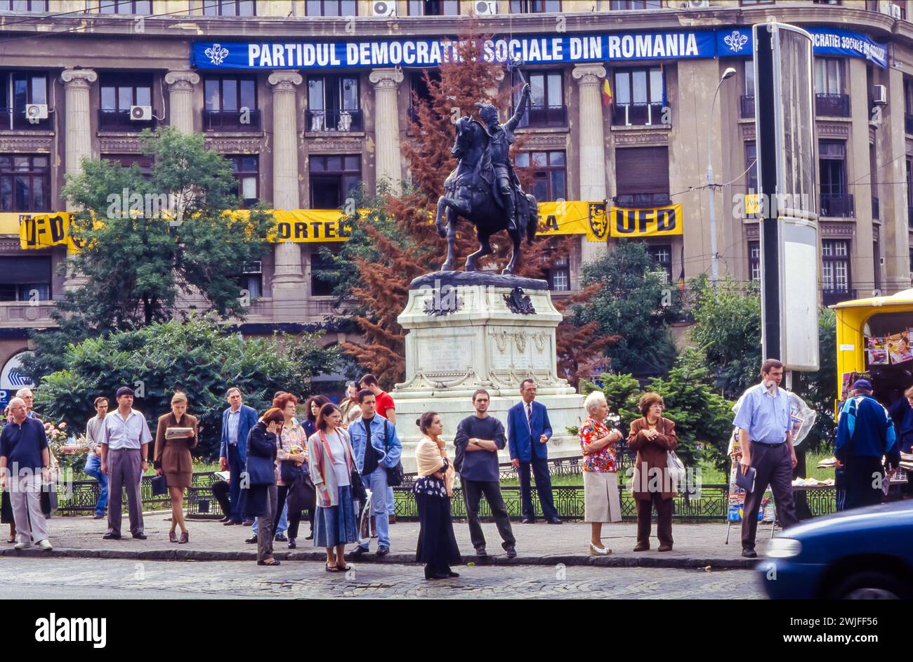 Romania, Bucharest, people waiting for a bus in front of building of the Social Democratic Party building. Stock Photo