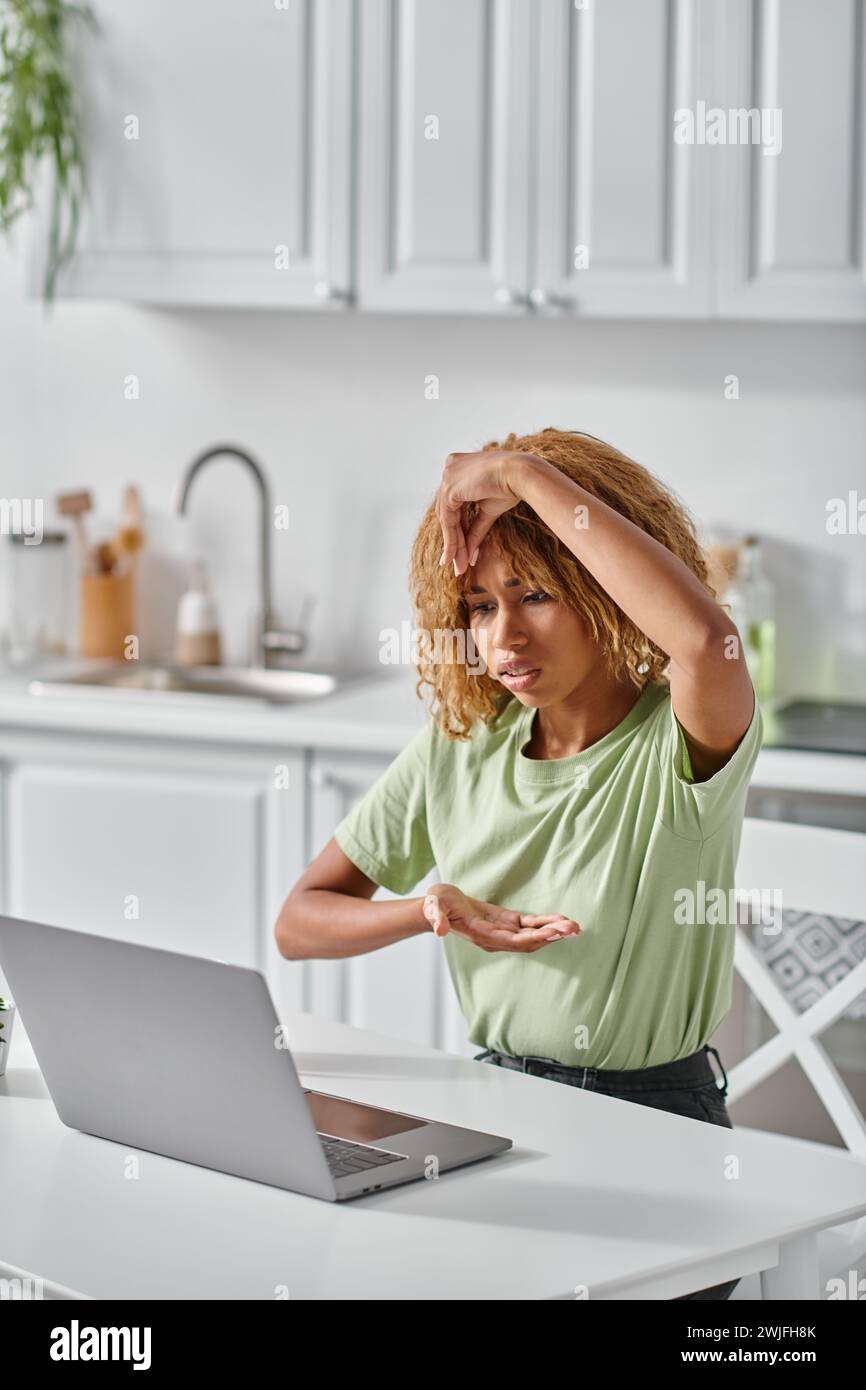 focused african american girl in braces using sign language during