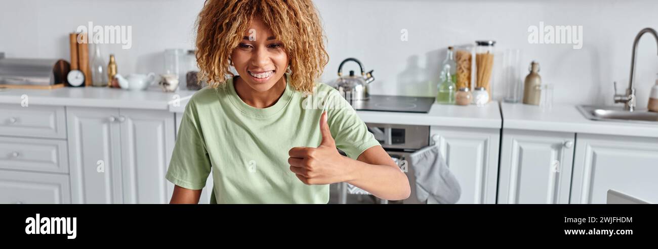 happy african american woman showing thumb up during video call on laptop, like gesture banner Stock Photo