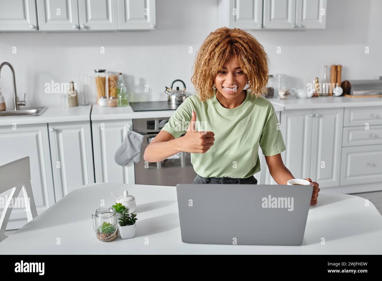 happy african american woman showing thumb up during video call on laptop, like gesture Stock Photo