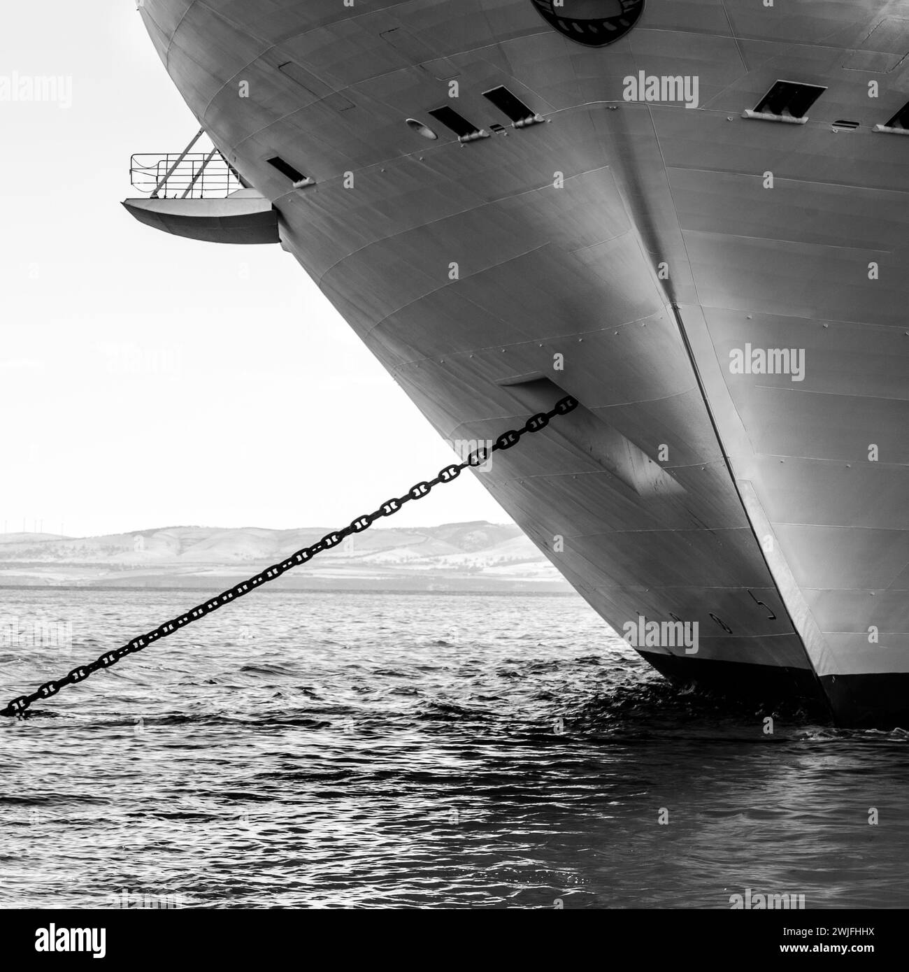 Black and white photo of a ship on beach with dock Stock Photo