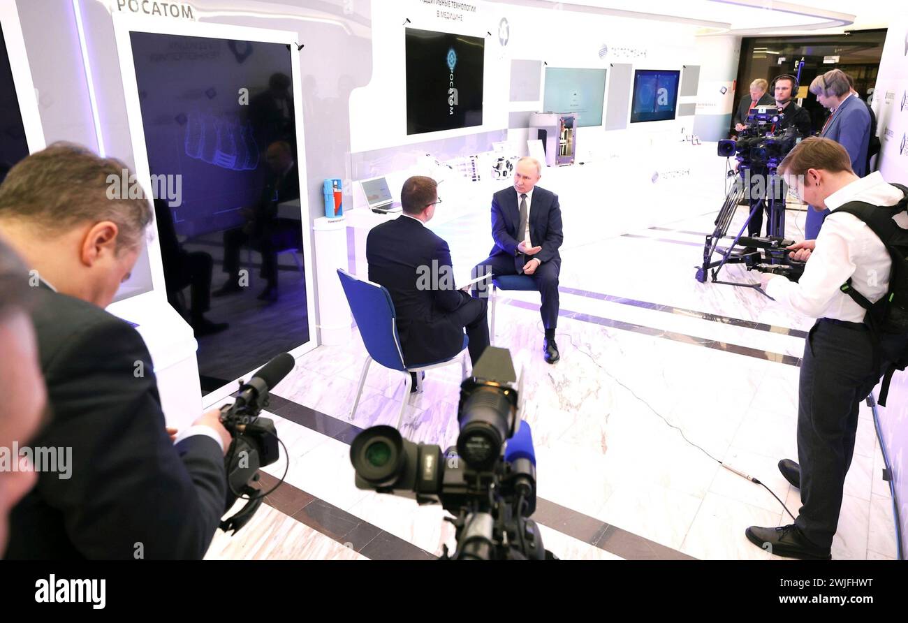 Moscow, Russia. 15th Feb, 2024. Russian President Vladimir Putin is interviewed by Rossiya One television journalist Pavel Zarubin, left, during the Future Technologies Forum at the Moscow World Trade Centre, February 14, 2024 in Moscow, Russia. The Future Technologies Forum showcases domestic scientific and medical progress. Credit: Alexander Kazakov/Kremlin Pool/Alamy Live News Stock Photo