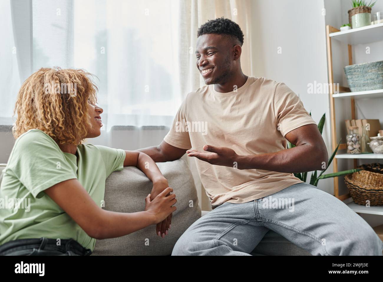 happy black man smiling while using sign language for communication