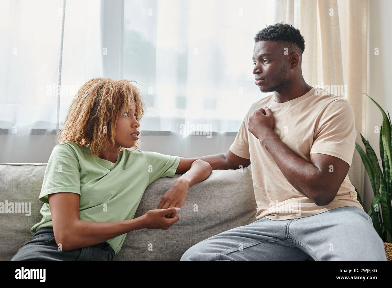 serious black man using sign language for communication with girlfriend