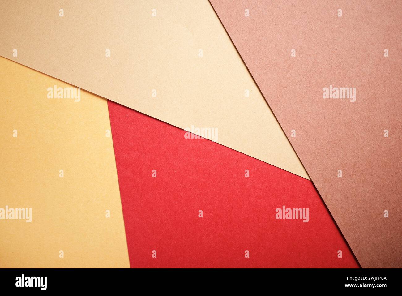 Background created with the foreground of stacked ochre cardstocks Stock Photo