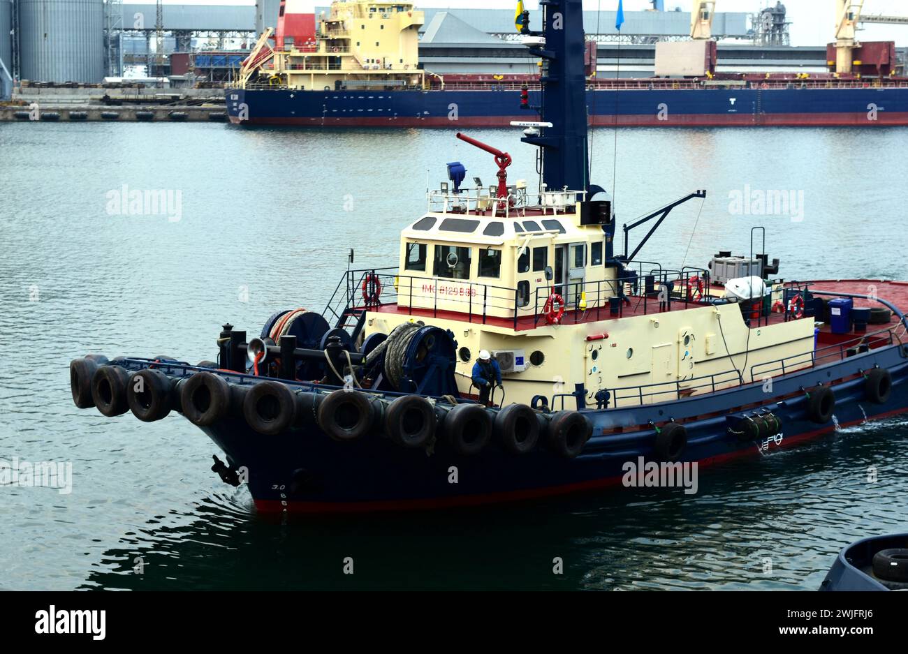 Ship tugboat entering port moored berth. High quality photo Stock Photo
