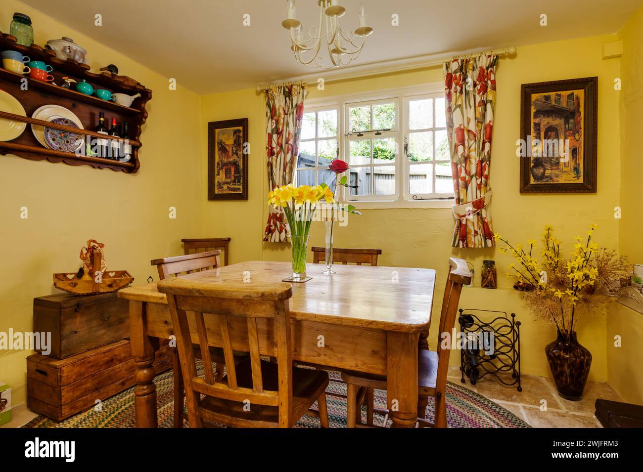 Dalham, Suffolk, England - Feb 19 2016: 16th Century english bright yellow cottage dinig room Stock Photo