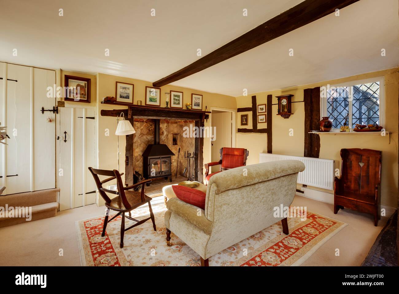 Dalham, Suffolk, England - Feb 19 2016: 16th Century cottage living room with fireplace Stock Photo