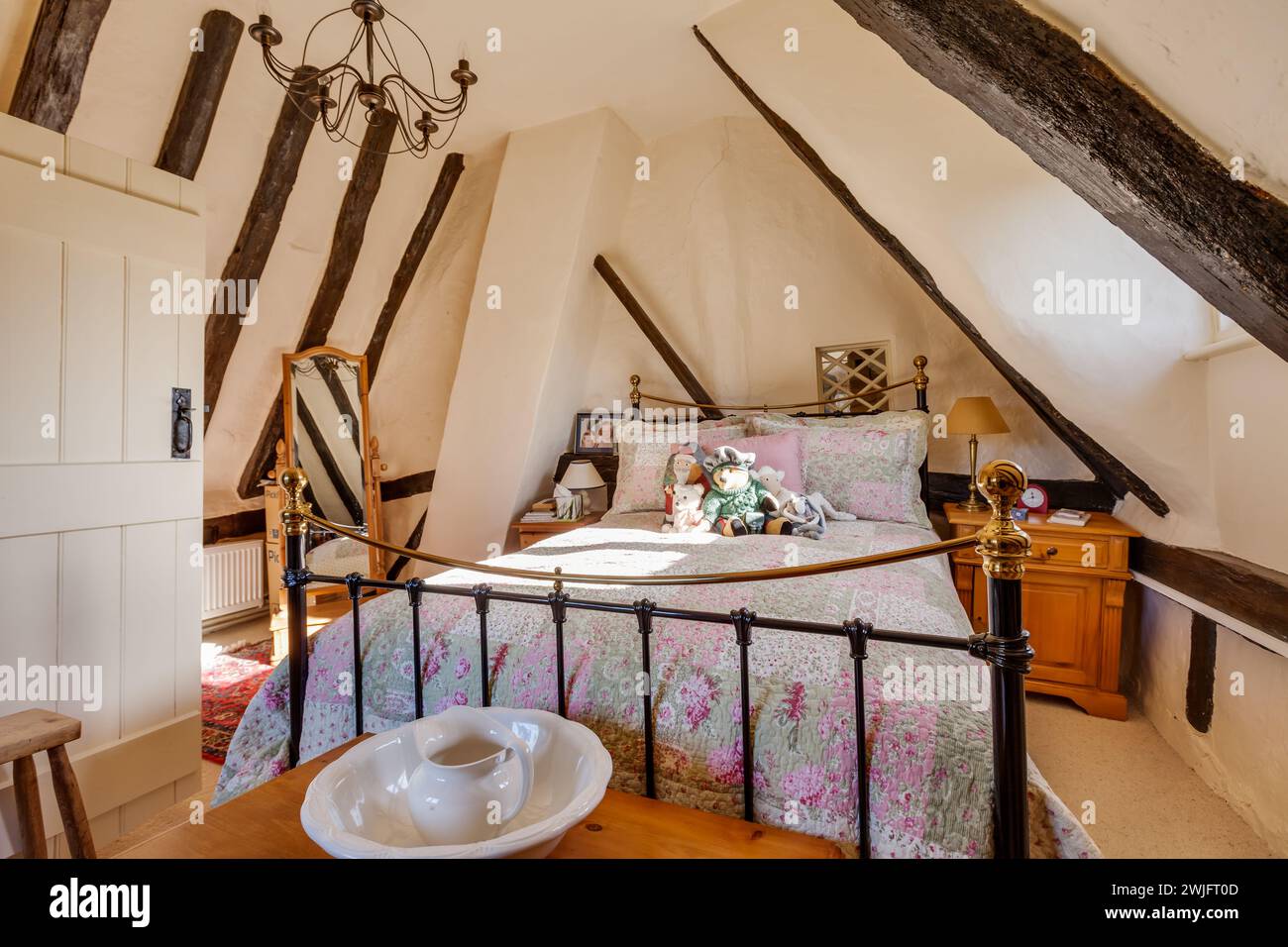 Dalham, Suffolk, England - Feb 19 2016: 16th Century english attic style cottage bedroom Stock Photo