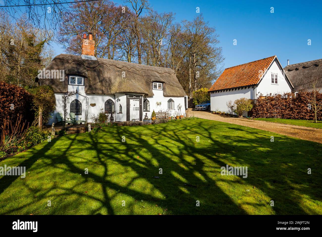 Dalham, Suffolk, England - Feb 19 2016: 16th Century thatched grade II listed cottage in sunlight Stock Photo