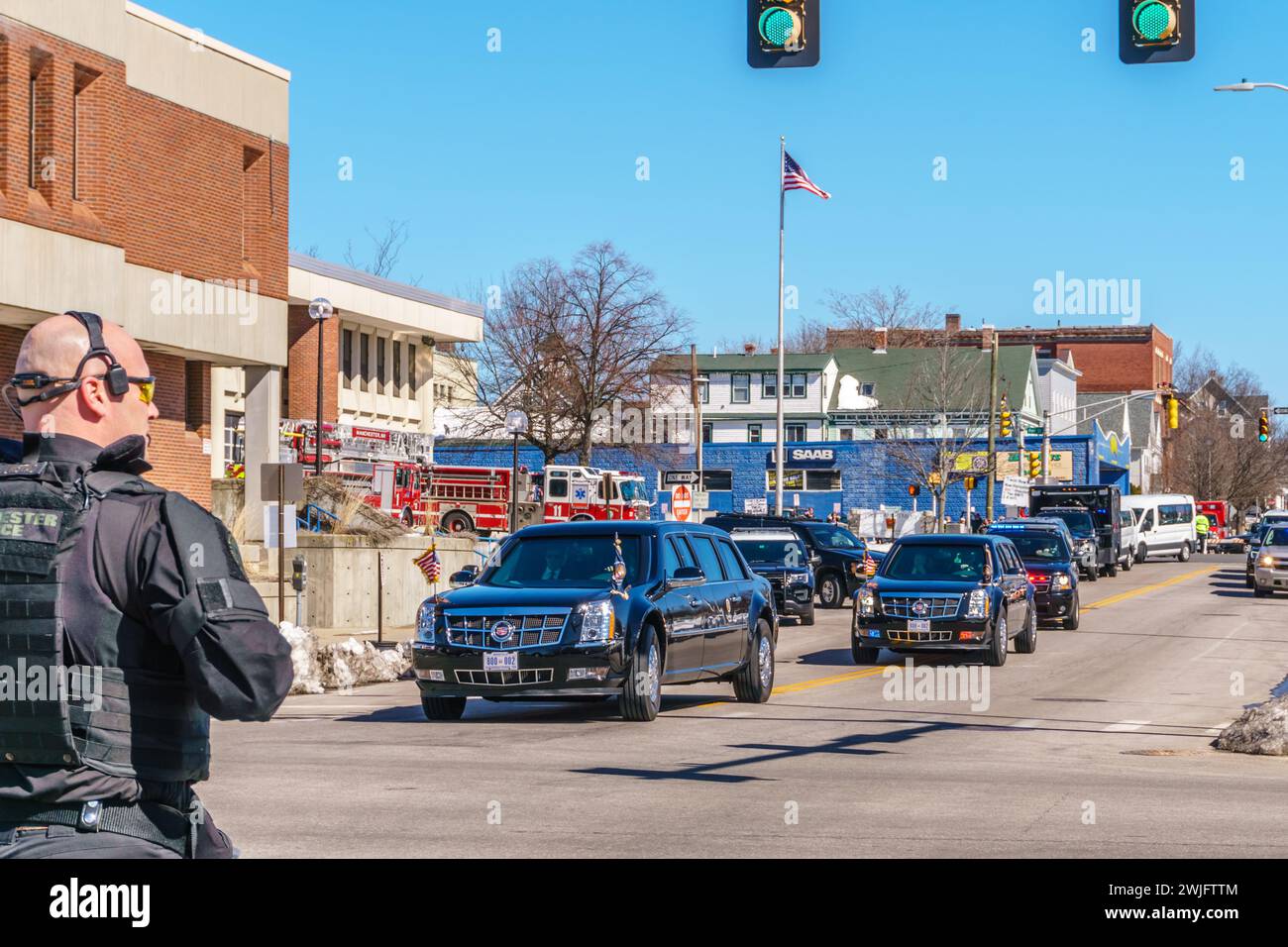 Manchester, NH/US-March 19, 2018: Police officer watches President Donald Trump's motorcade near fire station after giving speech on opioid epidemic. Stock Photo